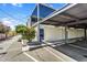 Modern apartment complex featuring covered parking and landscaped greenery against a sunny sky at 4411 N 40Th St # 59, Phoenix, AZ 85018
