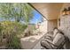 Relaxing covered back patio with ample seating, landscaping, and desert sunlight at 4531 W Continental Dr, Glendale, AZ 85308