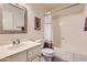 Clean bathroom featuring a white vanity, toilet, and tub with a neutral shower curtain at 4531 W Continental Dr, Glendale, AZ 85308