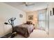 This bedroom features a single bed, ceiling fan, and access to natural light at 4531 W Continental Dr, Glendale, AZ 85308