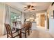 Bright dining room with a ceiling fan and large sliding doors, and an adjacent kitchen at 4531 W Continental Dr, Glendale, AZ 85308