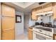 Cozy kitchen with wood cabinets, granite countertops, and a view into adjacent rooms at 4531 W Continental Dr, Glendale, AZ 85308