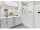 A clean and modern primary bathroom with double sinks, a walk-in shower, and neutral colors at 506 E Balao Dr, Phoenix, AZ 85085