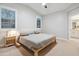 A primary bedroom featuring neutral tones, large windows, and a view into the primary bathroom at 506 E Balao Dr, Phoenix, AZ 85085