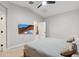 Neutral bedroom featuring a TV and view into another area of the house at 506 E Balao Dr, Phoenix, AZ 85085