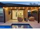 Relaxing covered patio with comfortable seating and an outdoor TV for entertainment at 506 E Balao Dr, Phoenix, AZ 85085