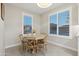 Cozy dining area with views from two windows featuring wood table and seating for four at 506 E Balao Dr, Phoenix, AZ 85085
