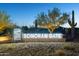 Night view of lit Sonoran Gate community entrance sign surrounded by desert landscaping at 506 E Balao Dr, Phoenix, AZ 85085