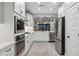 Stylish modern kitchen features stainless appliances and fixtures, along with an eat-in bar at 506 E Balao Dr, Phoenix, AZ 85085
