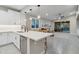 Open-concept kitchen with quartz countertops, stainless steel appliances, and a view of the living area at 506 E Balao Dr, Phoenix, AZ 85085