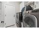 Modern laundry room with a gray washer and dryer set at 506 E Balao Dr, Phoenix, AZ 85085