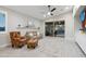 Bright living room featuring a ceiling fan, tile flooring, and sliding glass doors to the patio at 506 E Balao Dr, Phoenix, AZ 85085