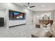 Spacious living room features built-in entertainment center, neutral tones, and tile flooring at 506 E Balao Dr, Phoenix, AZ 85085