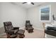 A home office with recliners, a computer, and lots of natural light at 506 E Balao Dr, Phoenix, AZ 85085