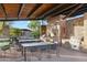 Outdoor kitchen and dining area with built-in grills and seating for large groups at 506 E Balao Dr, Phoenix, AZ 85085