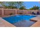 Inviting backyard pool with waterfall feature, surrounded by desert landscaping and lounge chairs at 506 E Balao Dr, Phoenix, AZ 85085
