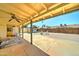 View of the backyard from the shaded patio that has a ceiling fan and a stone tile floor at 5347 W Seldon Ln, Glendale, AZ 85302