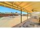 View of the backyard from the shaded patio that has a ceiling fan and a stone tile floor at 5347 W Seldon Ln, Glendale, AZ 85302