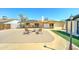 A spacious backyard featuring a built in bbq, stone tile, artificial turf, and a wood patio at 5347 W Seldon Ln, Glendale, AZ 85302