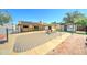 A spacious backyard featuring a built in bbq, stone tile, artificial turf, and a wood patio at 5347 W Seldon Ln, Glendale, AZ 85302