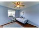 Light-filled bedroom with a cozy daybed, side table, and outdoor views from the window, a snug personal space at 5347 W Seldon Ln, Glendale, AZ 85302