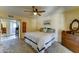 Inviting bedroom features neutral walls, ceiling fan, and comfortable carpeting, creating a warm and restful atmosphere at 5347 W Seldon Ln, Glendale, AZ 85302