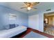 A blue hued bedroom with neutral carpet offering a closet, and light, ideal for rest and relaxation at 5347 W Seldon Ln, Glendale, AZ 85302