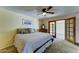 This neutral bedroom includes a ceiling fan, carpet, and sliding doors to the yard, creating a tranquil retreat at 5347 W Seldon Ln, Glendale, AZ 85302