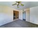 Comfortable bedroom with a ceiling fan, closet, and access to the backyard through the french doors at 5347 W Seldon Ln, Glendale, AZ 85302