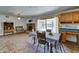 Dining area with brick floors, a fireplace, a sliding glass door, and kitchen access at 5347 W Seldon Ln, Glendale, AZ 85302