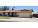 Charming single-story home featuring a well-manicured lawn, attached garage and neutral-colored exterior at 5347 W Seldon Ln, Glendale, AZ 85302