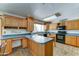 Well-lit kitchen with ample counter space, light wood cabinets, and modern appliances at 5347 W Seldon Ln, Glendale, AZ 85302