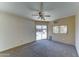 Spacious living room with carpet and sliding glass doors that open to the pool and backyard, perfect for seamless indoor/outdoor living at 5347 W Seldon Ln, Glendale, AZ 85302