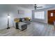Inviting living room with a gray sectional sofa, wood-look floors, and plenty of natural light at 5347 W Seldon Ln, Glendale, AZ 85302