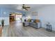 Bright living room featuring modern wood-look floors and cozy gray sectional at 5347 W Seldon Ln, Glendale, AZ 85302