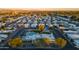 Neighborhood aerial view with community pool, clubhouse and manicured landscaping during a colorful sunset at 535 S Alma School Rd # 85, Mesa, AZ 85210