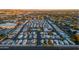 Expansive aerial shot of a vibrant neighborhood with well-arranged homes and lush greenery during sunset at 535 S Alma School Rd # 85, Mesa, AZ 85210