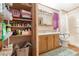Compact bathroom featuring wood cabinets, shower and storage shelving at 535 S Alma School Rd # 85, Mesa, AZ 85210
