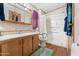 Functional bathroom with wood cabinets, a walk-in shower, and a clean, practical design at 535 S Alma School Rd # 85, Mesa, AZ 85210