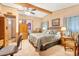 Comfortable bedroom featuring a wood bed frame, ceiling fan, and an attached bathroom at 535 S Alma School Rd # 85, Mesa, AZ 85210
