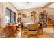 Cozy dining room with a round table, decorative chandelier, and built-in shelving at 535 S Alma School Rd # 85, Mesa, AZ 85210