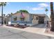 Charming home with an American flag, landscaped yard, covered parking, and serene neighborhood street view at 535 S Alma School Rd # 85, Mesa, AZ 85210