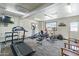 Bright fitness center featuring various exercise equipment, natural light from a window, and sleek flooring at 535 S Alma School Rd # 85, Mesa, AZ 85210