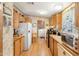 Functional kitchen featuring light wood cabinets, laminate countertops, and essential appliances at 535 S Alma School Rd # 85, Mesa, AZ 85210