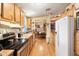 Well-lit kitchen showcasing wood cabinets, modern appliances, and a view into the adjacent dining area at 535 S Alma School Rd # 85, Mesa, AZ 85210