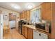 Functional kitchen with wood cabinets, stainless steel appliances, and a convenient laundry area at 535 S Alma School Rd # 85, Mesa, AZ 85210