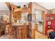 Kitchenette with cozy bar top seating, wood cabinets, and seamless access to the kitchen at 535 S Alma School Rd # 85, Mesa, AZ 85210