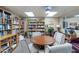 Well-stocked library features bookshelves and table with rolling chairs, creating a comfortable reading environment at 535 S Alma School Rd # 85, Mesa, AZ 85210