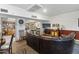 Cozy lounge area with leather sofa, TV, library access, and a bar-height table with chairs at 535 S Alma School Rd # 85, Mesa, AZ 85210