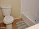 Clean bathroom featuring a white toilet, bathtub and neutral colored flooring at 549 E Mckellips Rd # 18, Mesa, AZ 85203